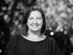 Black and white photo of Juliana Tadano in front of blurry background